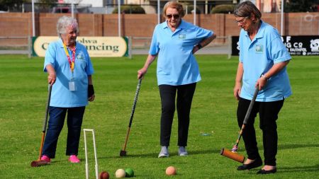 Group of older women playing Croquet 