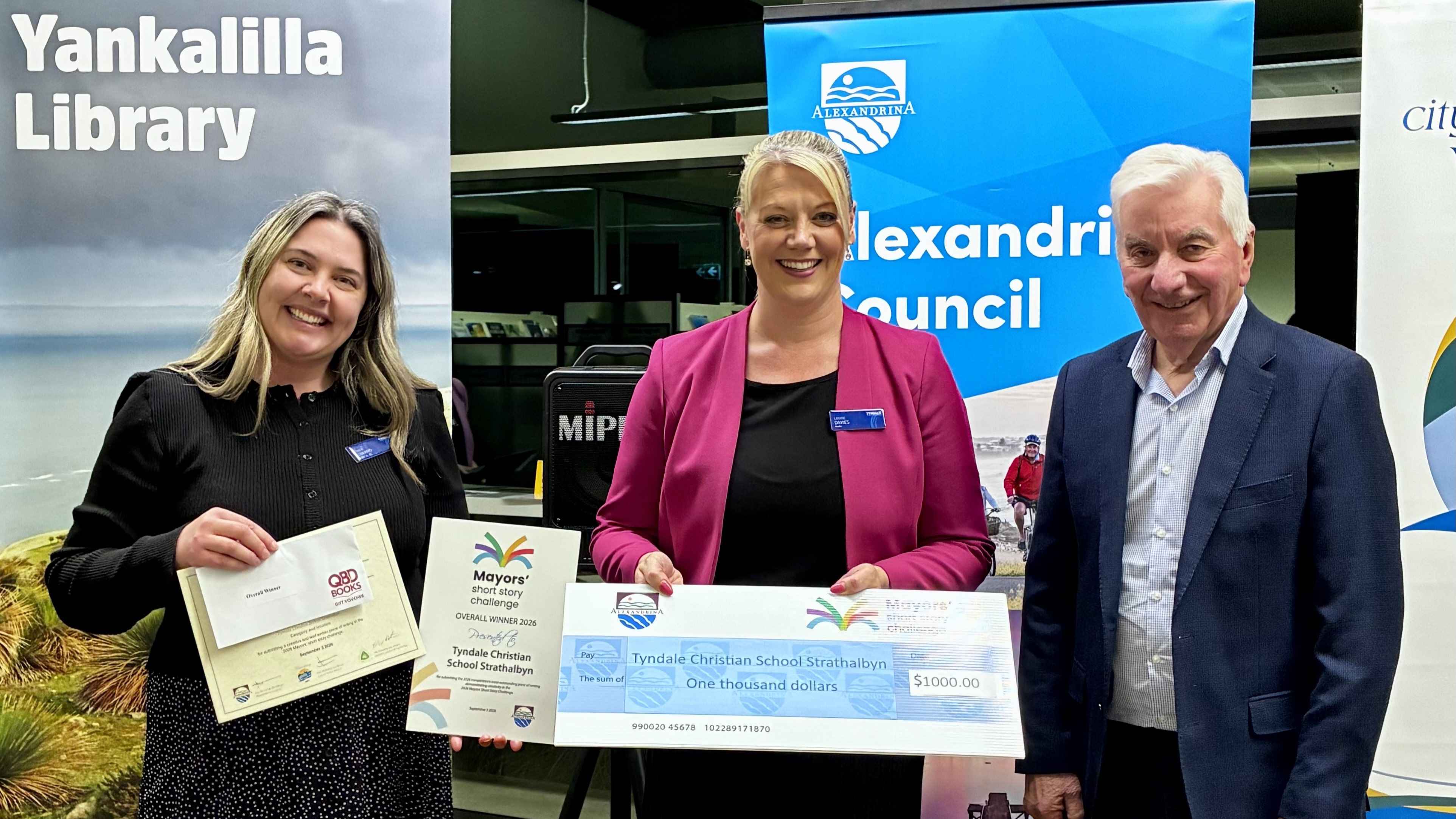 Louise Davies and Amber Howard from Tyndale Christian School Strathalbyn with Mayor Parks on behalf of overall Winner Malachi Shigrov (absent) holding school plaque