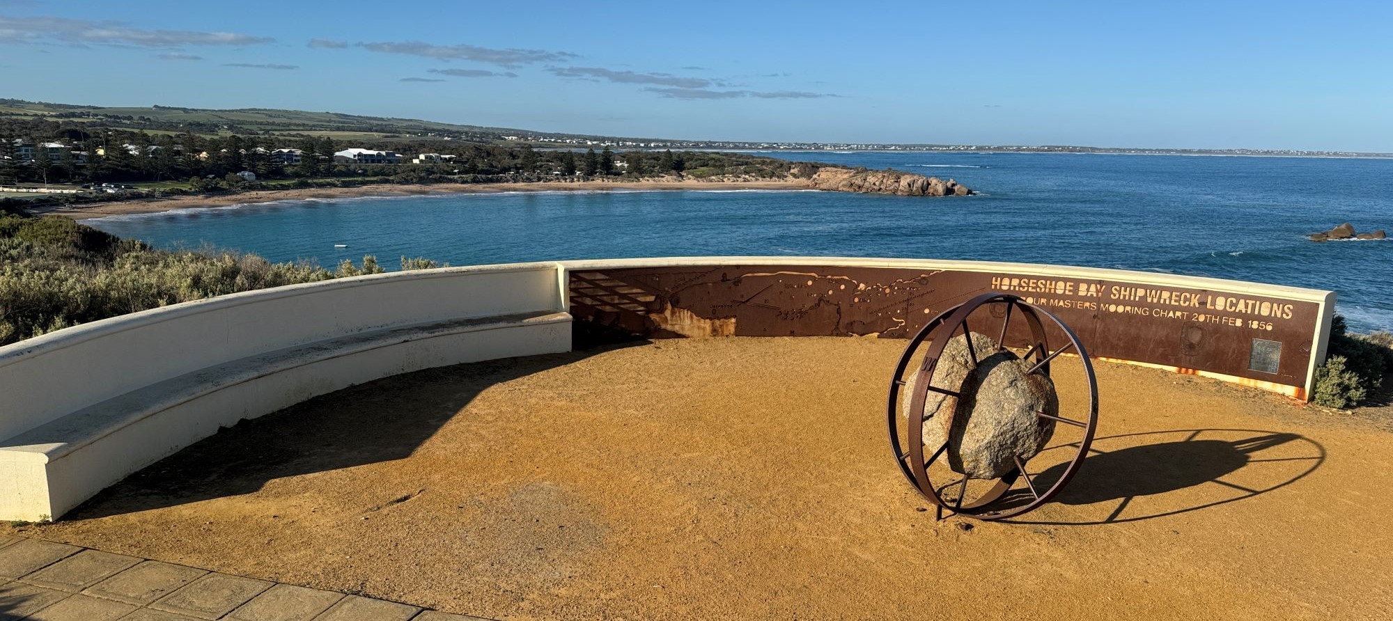 Stone and metal artwork in centre of semi-circle of seating at lookout over Horseshoe Bay, Port Elliot.