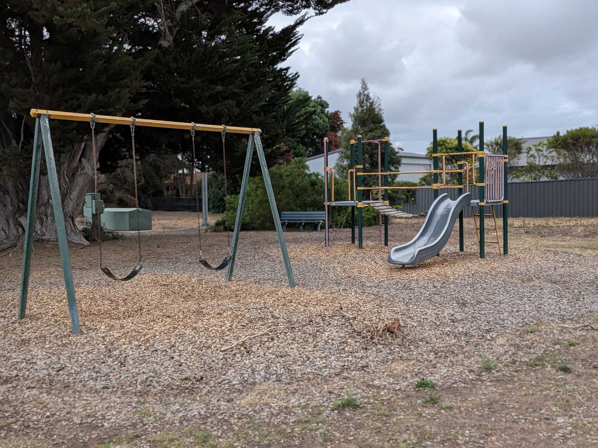 Garden Reserve playground with swing set, platform and slide.
