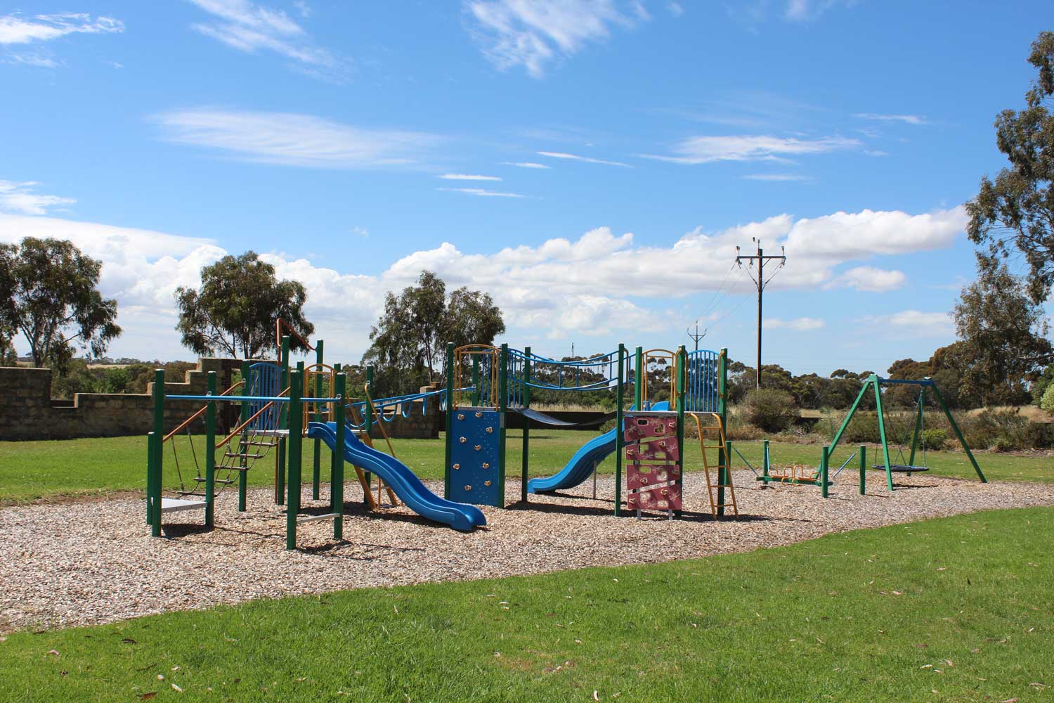 Angas Glen Reserve Playground with play platforms, swing, climbing wall and slides