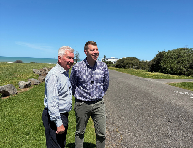 Mayor Keith Parkes and Mayor and Transport Minister Joe Szakacs stand on the grass beside Mill Terrace at Middleton.