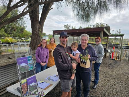 Group of people celebrating after collecting their native plant pack