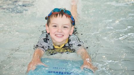 Child Swimming in Pool