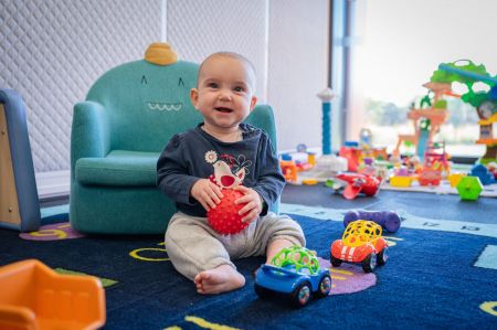 Photo of a baby playing with toys